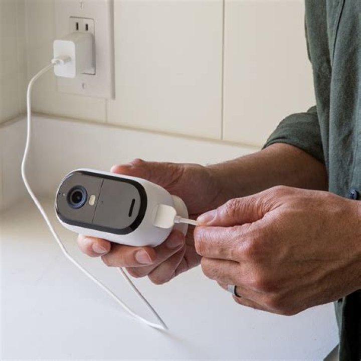How do I sync my Arlo camera after changing the battery?