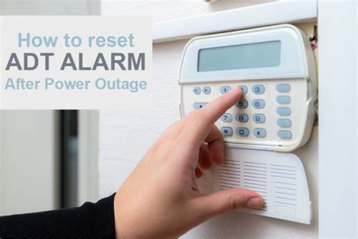 How do you reset a security alarm after a power outage?