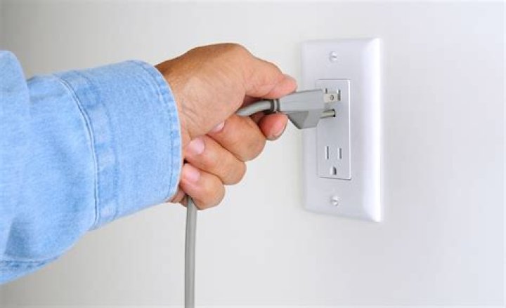 What appliances should be unplugged during a power outage?